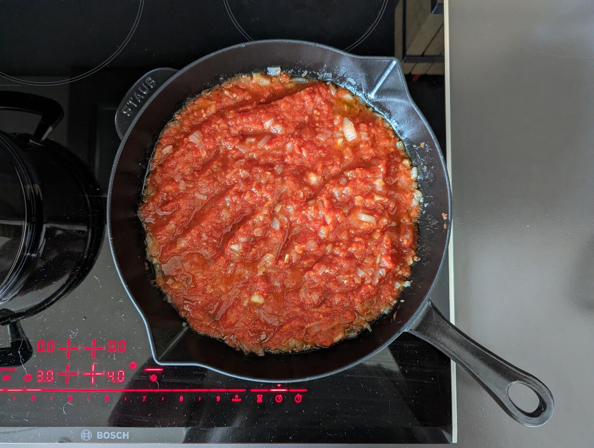 Tomatoes, onion, and garlic in a pan