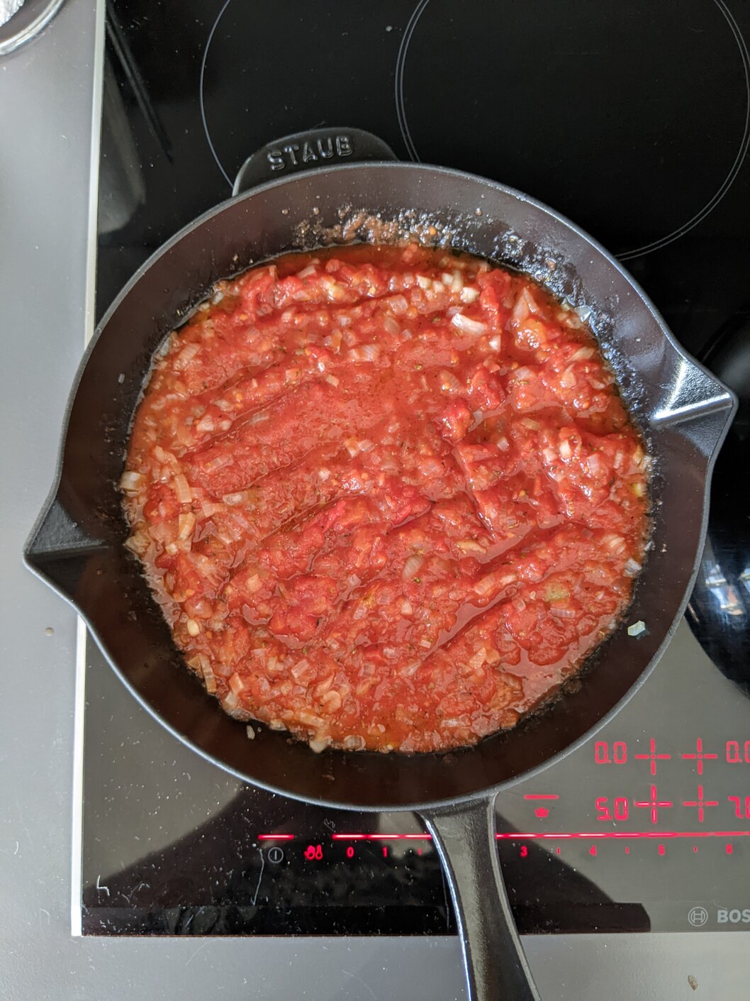 Chopped onion and tomatoes in a pan